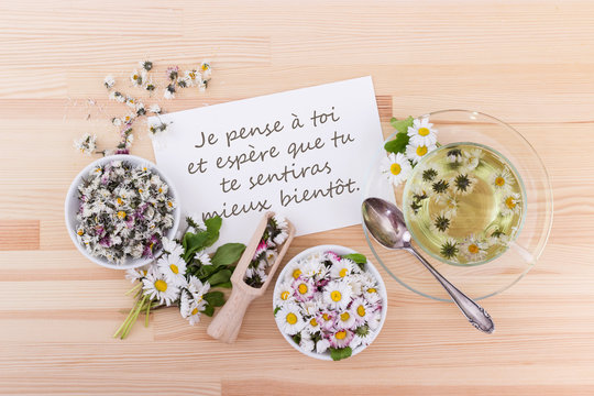Fototapeta Get well / Card for recovery with tea and daisies and french text:  I think of you. I hope for your speedy recovery