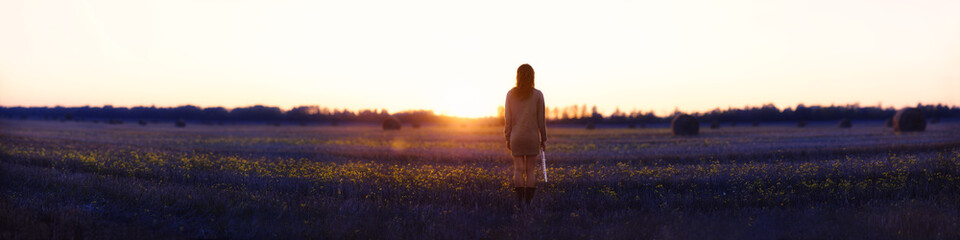 lonely girl flutist at sunset in the field. It can be used as a cover of the book or an album