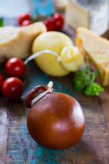 Traditional Italian hard cheese Provolone of Caciocavallo, smoked and white