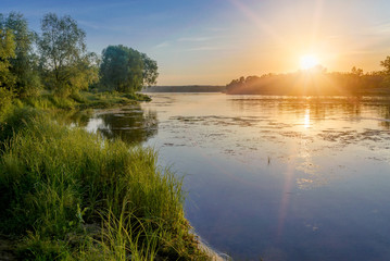 Fototapeta na wymiar Sunset over the Dnieper river in Kiev, Ukraine, during a warm summer evening.