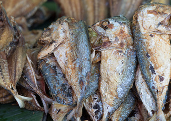Closeup of small grilled fish at the outdoor street food market