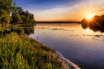 Fototapeta na wymiar Sunset over the Dnieper river in Kiev, Ukraine, during a warm summer evening.