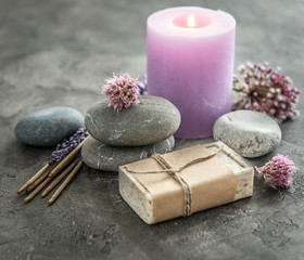 violet candle, bar of homemade soap in paper