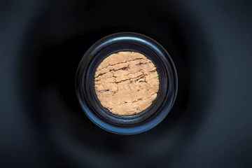 Fototapeten cork in the wine bottle and blurry background, photographed from above for winemaker business card or book cover © zozzzzo