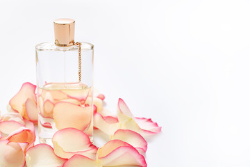 Perfume bottle with flower petals on light background. Perfumery, fragrance collection. Women...