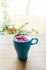 Blue cup of aroma warm cappuccino on wooden table. Relax commerce concept