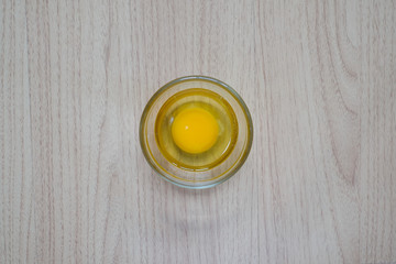 Close-up view of raw chicken eggs on wooden background