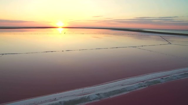 Aerial view 4k. Fabulous sunset at the dead salt sea. Pink salt brine.