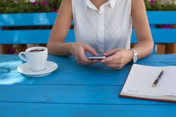 Young urban woman texting on the phone outdoors