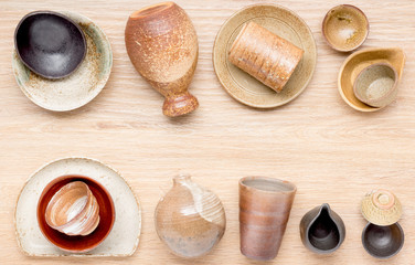 collection of traditional japanese style pottery on wood background, top view