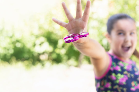 Girl playing with a fidget spinner toy