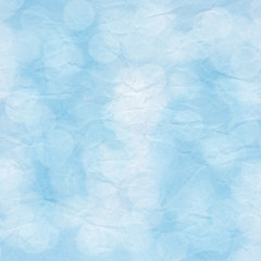 Bokeh light on blue crumpled paper
