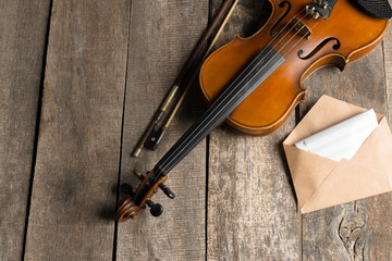 Fototapeta na wymiar Sheet music and violin on wooden table