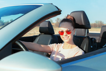 Relaxed happy woman traveling in a car