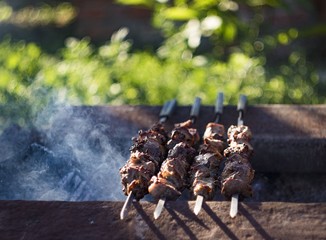 closeup of some meat skewers being grilled in a barbecue