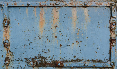 Old rusted metal plate with rivets