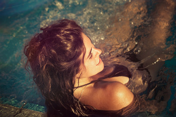 young woman in pool enjoy in warm sun real people concept