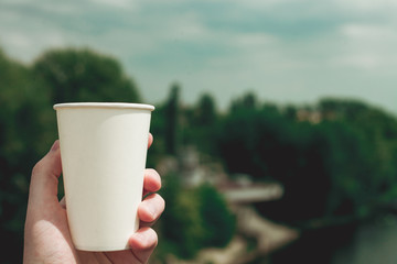 Paper cup on a background of urban landscapes