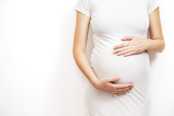 Young, pregnant woman on white background