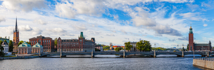 Fototapeta premium STOCKHOLM, SWEDEN - SEPTEMBER 17, 2016: Gamlastan and Town Hall. Panoramic view with bridge