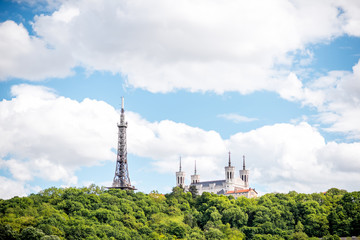 Obraz premium View on the mountain with Notre-Dame cathedral and metallic tower in Lyon city in France