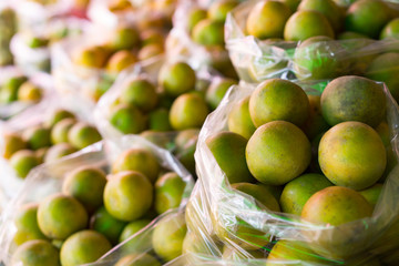 Fresh mandarin orange background on the fruit market showcase.