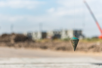 metal plumb line used in construction site
