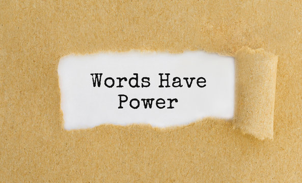 Text Words Have Power appearing behind ripped brown paper