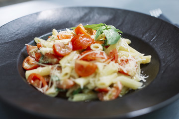 Penne pasta with cheese and cherry tomato