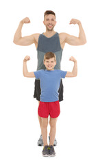 Dad and son showing muscles on white background