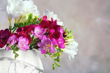 Fototapeta na wymiar Bunch of beautiful freesia flowers on blurred background