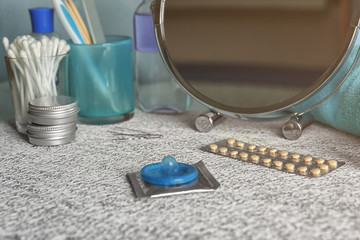 Birth pills and condoms on table. Contraception concept