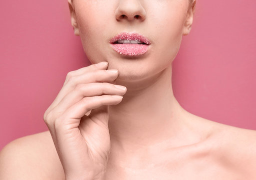 Woman with sugar lips on color background