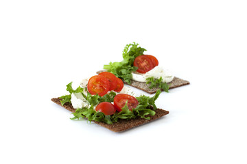 Healthy snack from wholegrain rye crispbreads crackers with Cherry tomatoes, salad and goat cheese