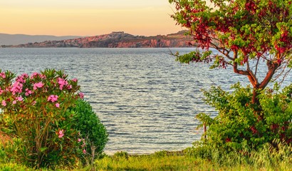 A view of the bay of Moliyvos with castle in the evening red on the island of Lesbos in Greece in...