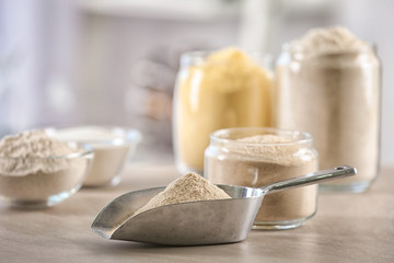 Fototapeta na wymiar Metal scoop with flour on table