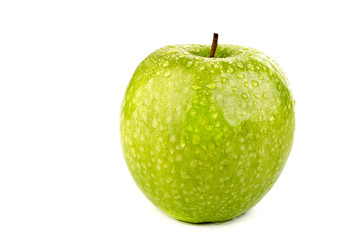 Bright ripe green apple in water drops