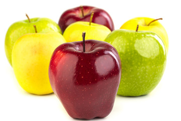 Ripe red, yellow and green apples on white background