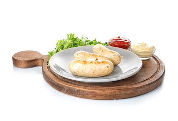 Plate with delicious grilled sausages on wooden board, isolated on white