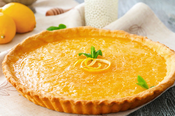 Tasty lemon curd on table, closeup