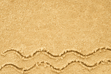 Fototapeta na wymiar sea waves drawing in sand