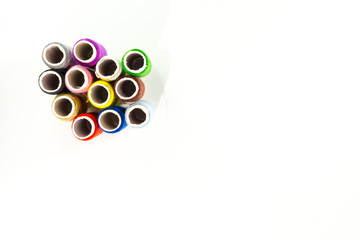 Colored thread coils on white background