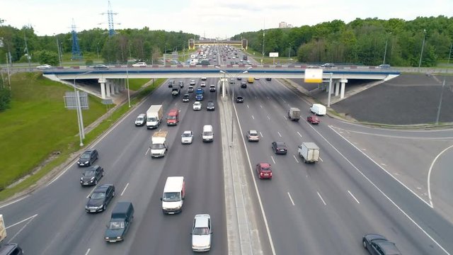 Heavy traffic at road bridge above highway.