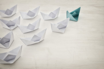 leadership concept, yellow paper boat leading followers