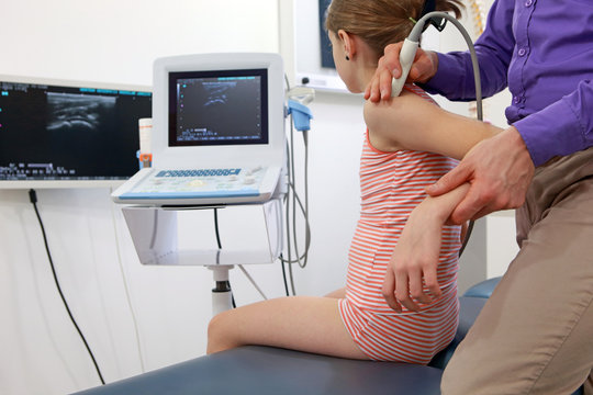 caucasian girl's arm diagnosis carried out with the use of an ultrasound