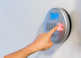 woman hand using silver biometric scan with red fingerprint sensor