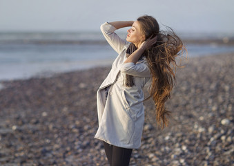 Portrait of a girl, model on a windy day by the sea. Portrait, beauty, tenderness.