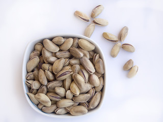Pistachio nuts isolated in plates