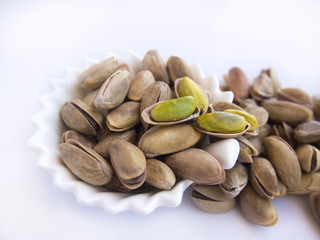 Pistachio nuts isolated in plates
