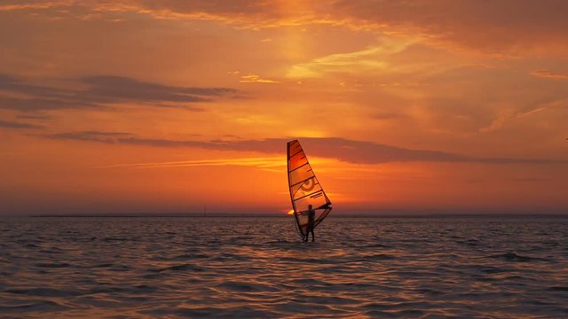 Windsurfing at breathtaking view of sunset
